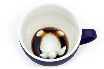 Ceramic dark blue coffee cup with 3D turtle design. 