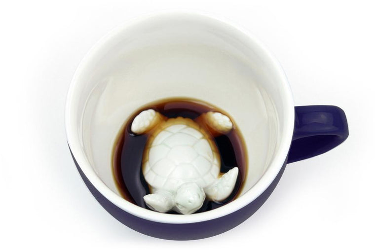 Ceramic dark blue coffee cup with 3D turtle design.