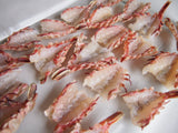 Raw and split cleaned rock shrimp laid open on white plate thumbnail