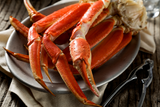 Snow crab clusters on plate with crab crackers on the side thumbnail