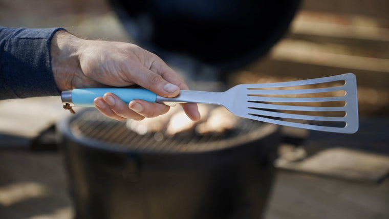 Hand holding a fish spatula